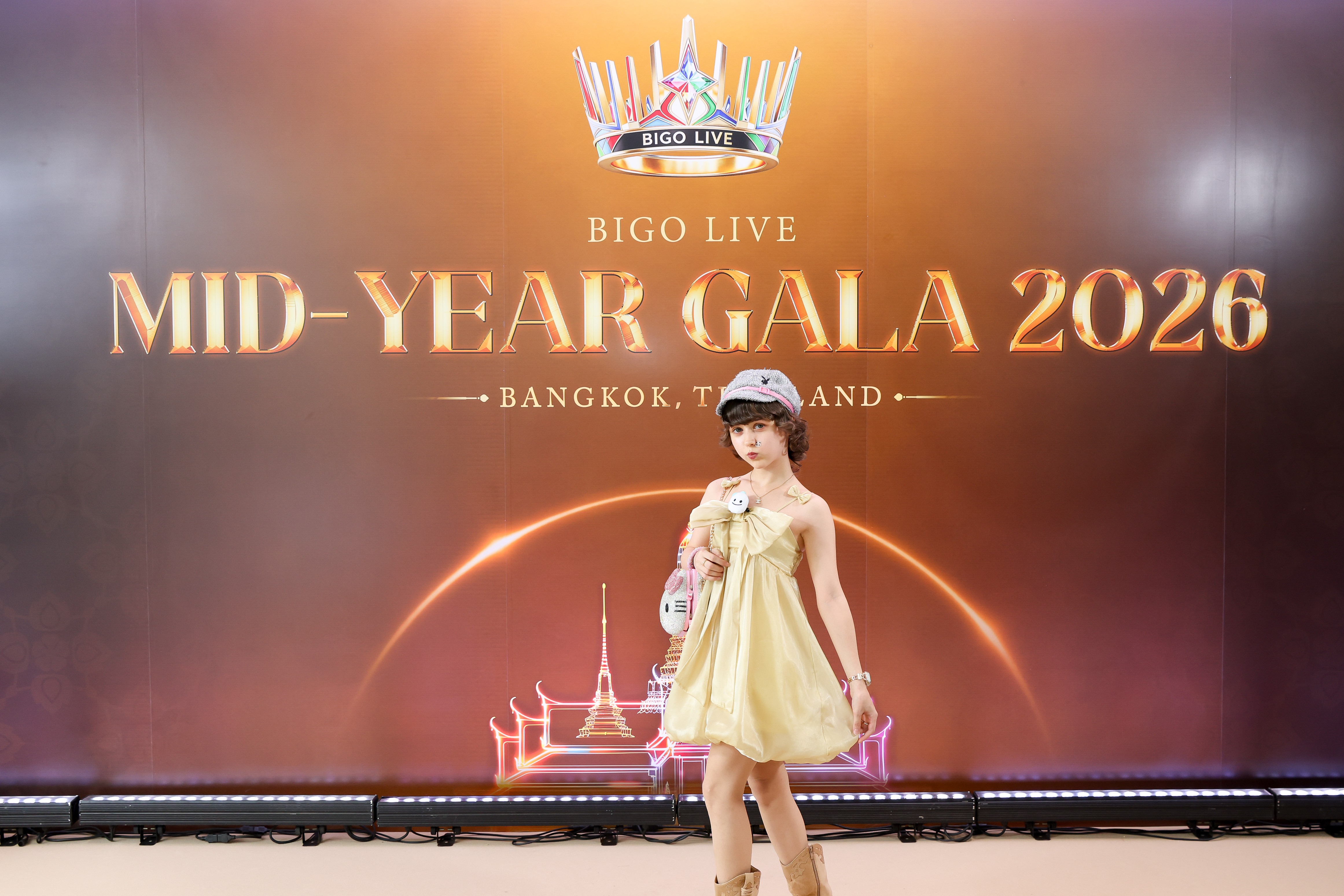 Melanie walking toward camera in front of the Bigo Gala 2026 sign